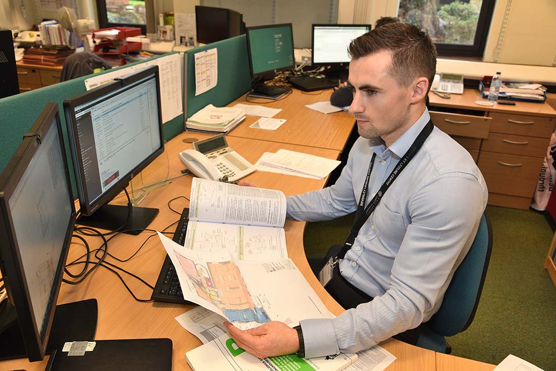 Building control officer carrying out plan check assessments in the office