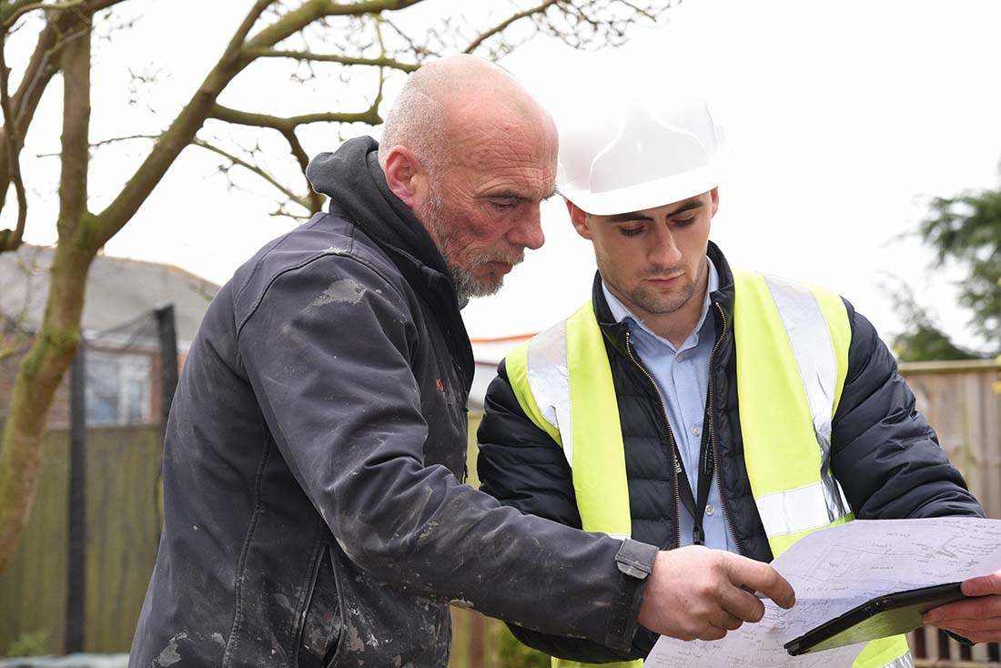 Building control officer discussing work with a builder