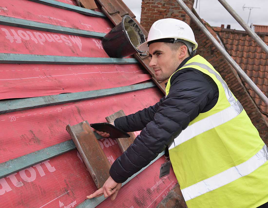 Building control officer on site inspecting a re-roofing job