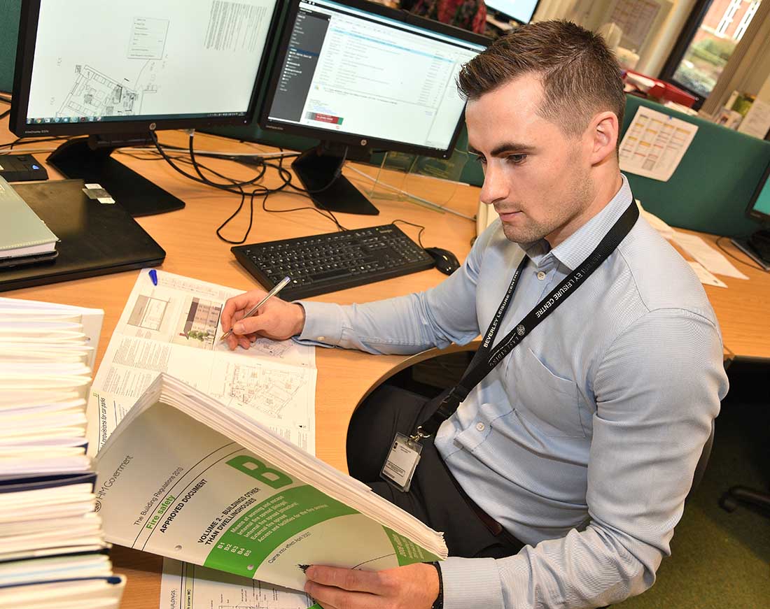 Building control officer researching technical information on construction